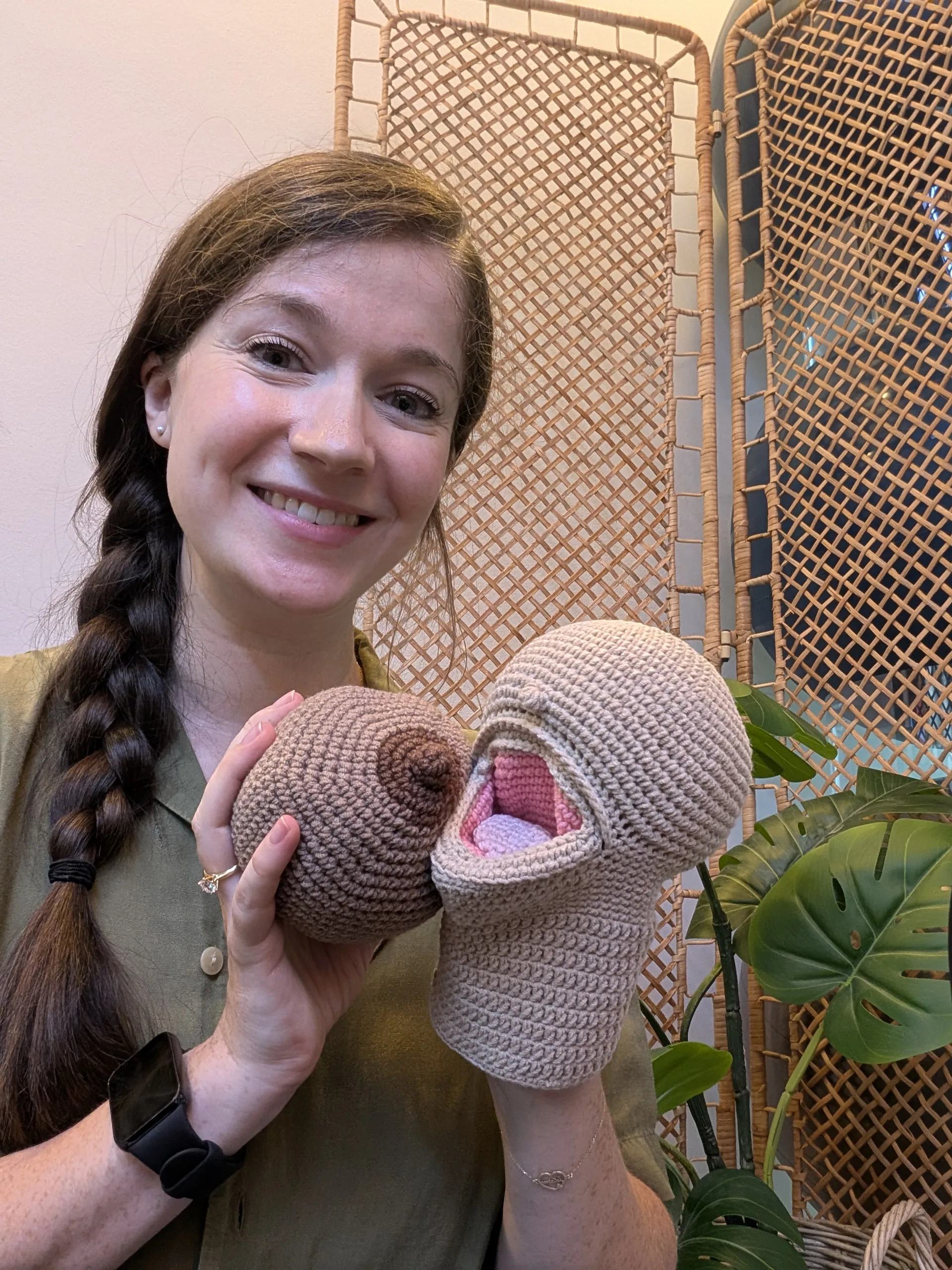 Charlotte demonstrating breastfeeding latch with crochet puppets